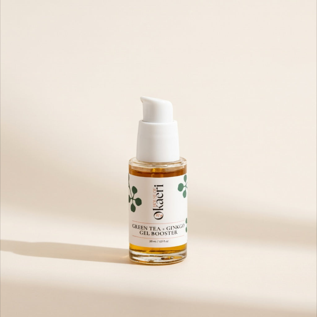 A small clear bottle of House Okaeri Green Tea + Ginger Gel Booster with a white pump dispenser and white label, set against a warm beige background with a soft shadow.