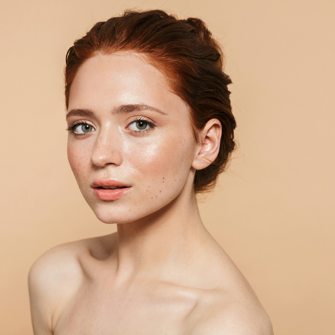 Woman with short brown hair against a beige background

